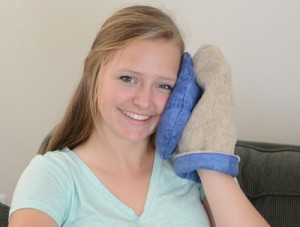 Teenager using a Hand Warmer Insert as a heating pad that is soft on the face