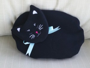 Black Cat microwave heating pad decorating a chair