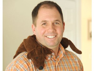 Man using microwave Dachsund Neck heating pads to relax stiff neck muscles