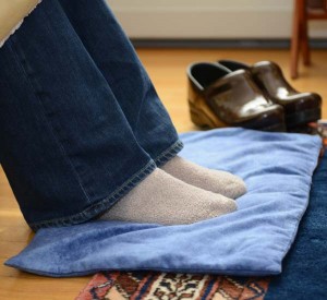 Woman warming feet on microwave heating pad