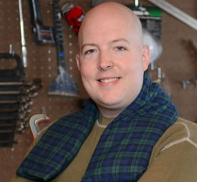 Man using extra long neck warmer while working in a cold woodshop