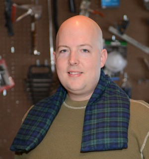 Man using extra large neck warmer to help stay warm in a wood shop