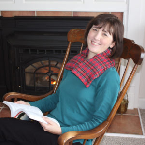 Traditional Neck Wrap relaxes stiff muscles for this woman in a rocking chair