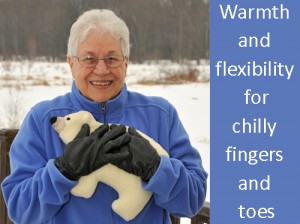 Woman using a Polar Bear microwave heating pad to warm cold hand while outside in winter