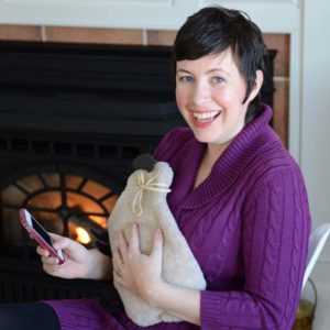 Woman using microwave sheep warmer to warm up