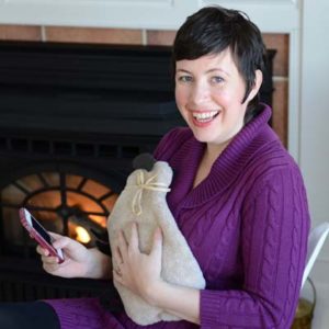 Woman warming hands on Sheep Warmer