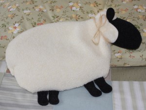 Maine Warmers White Sheep decorating a bed