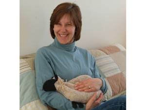 Woman using sheep microwave heating pad to relieve periodic cramps