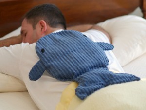 Man resting in bed with a whale extra large microwave heating pad for the back