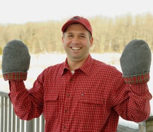 Man warming cold hands with reusable hand warmer mittens