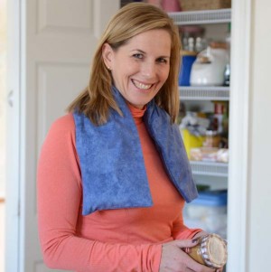 Woman using extra long neck warmers while preparing a pantry meal