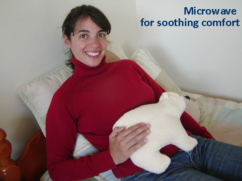 Woman using Polar Bear microwave heating pad to relieve cramps from menstruation