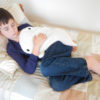 Boy sleeping with a white whale microwave heating pad