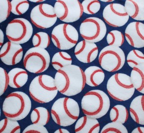 Print plush fabric with blue background, white baseballs and red stitching for baseball enthusiasts