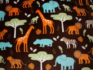 Jungle Print Plush fabric in brown with giraffes, elephants, zebras. and more animals in orange, blues, and greens meant for a child
