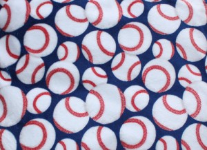 White baseballs with red thread on a royal blue background printed on high qualtiy plush fabric