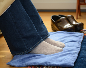 Woman warming feet on extra large back warmer