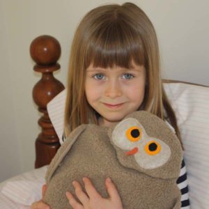 Girl using Tan Owl body warmer and muscle relaxer to warm her hands