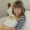 Girl using Snowy Owl bed warmer