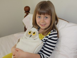 Girl using Snowy Owl bed warmer