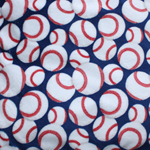Plush fabric with red & white baseballs on a blue background