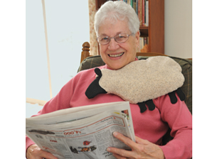 Woman warming up with Cozy Sheep microwave heating pad and body warmer