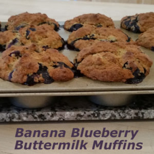 Muffin tin with freshly baked banana blueberry buttermilk gluten-free muffins