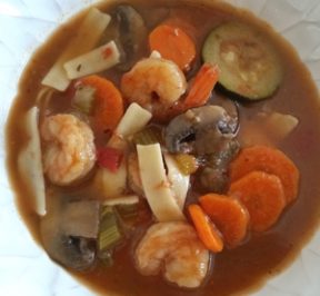 Maine Warmers shrimp & veggies with gluten-free pasta in a white bowl