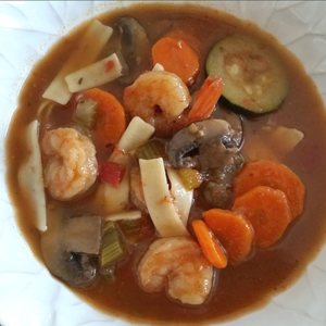 Maine Warmers shrimp & veggies with gluten-free pasta in a white bowl