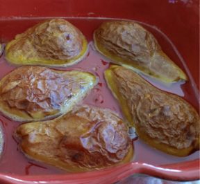 Baked Pear halves in a red ceramic casserole dish
