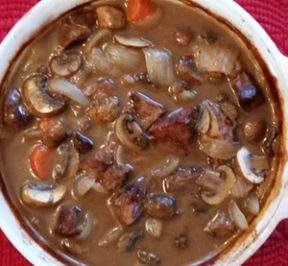 Beef Bourguignon in a white casserole dish