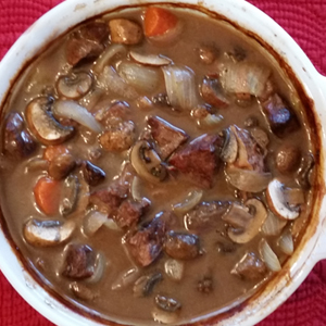 Beef Bourguignon in a white casserole dish